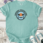 Mint green t-shirt with 'Permanent Vacation Mode' graphic, featuring palm trees and sunset design.