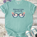 Mint green t-shirt with 'Retirement Looks Good On Me' graphic and sunglasses design.