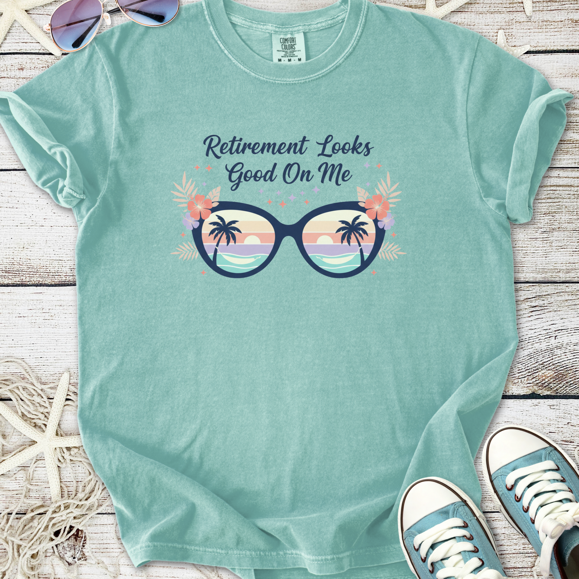 Mint green t-shirt with 'Retirement Looks Good On Me' graphic and sunglasses design.