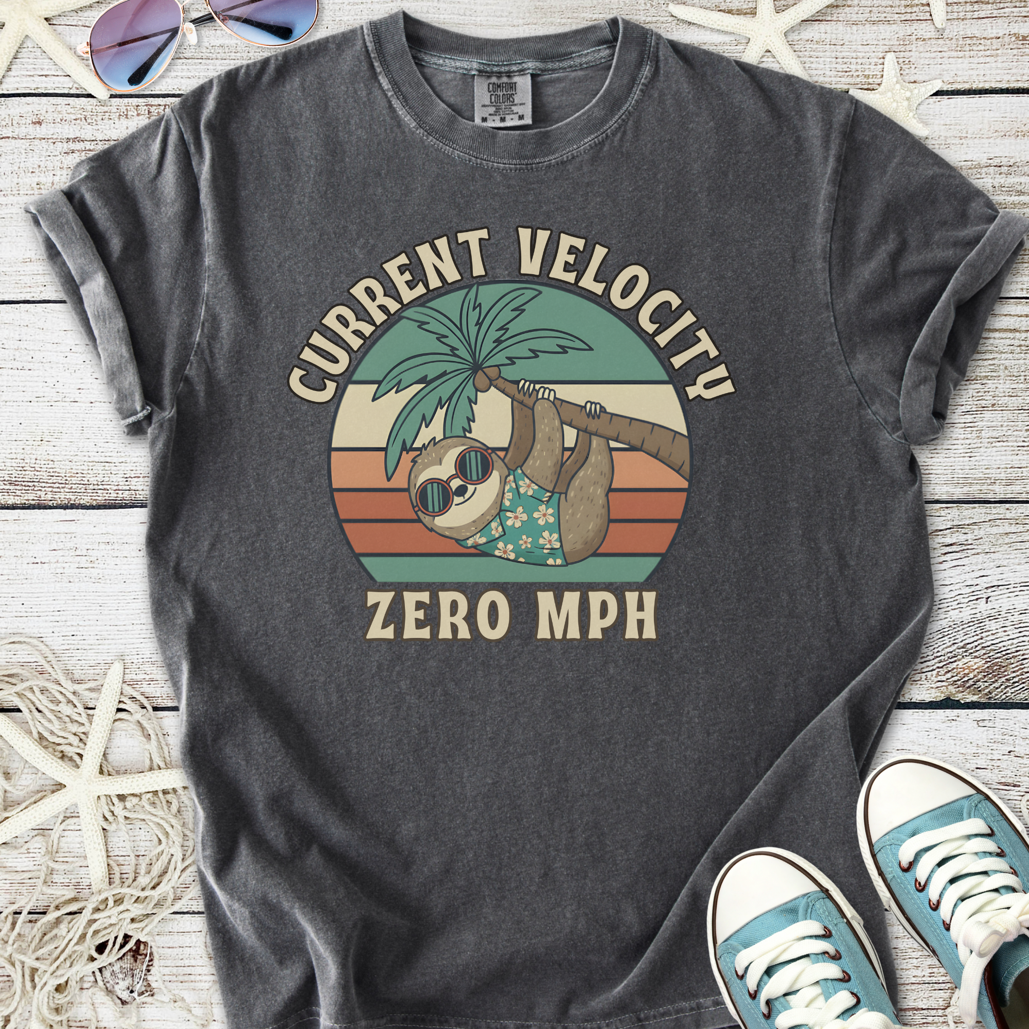 Men's graphic t-shirt featuring a lazy sloth, retro colors, and palm tree design, in charcoal gray.