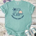 Mint green t-shirt featuring a dog, palm tree, and sunset with 'Pawsitive Vibes Only' slogan.