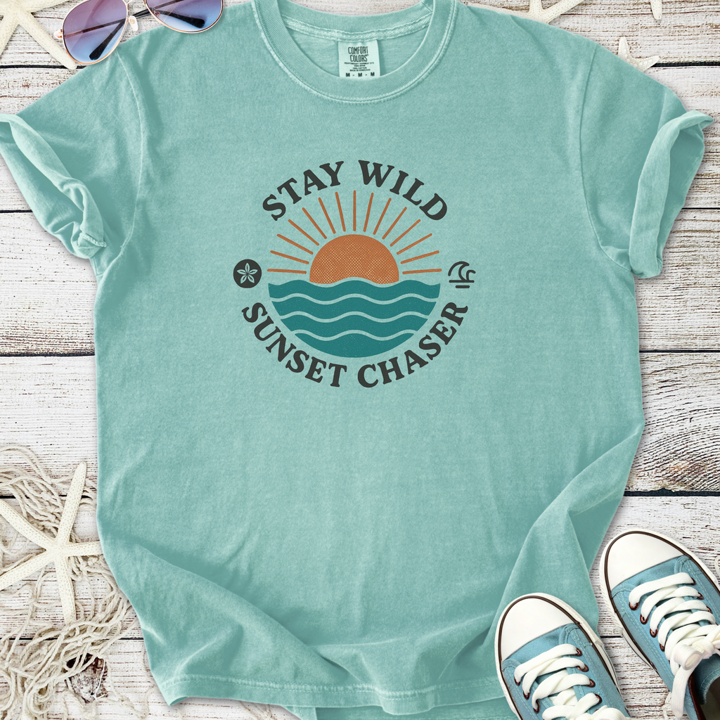 Mint green t-shirt with 'Stay Wild Sunset Chaser' graphic, featuring sun and waves design, perfect for summer.
