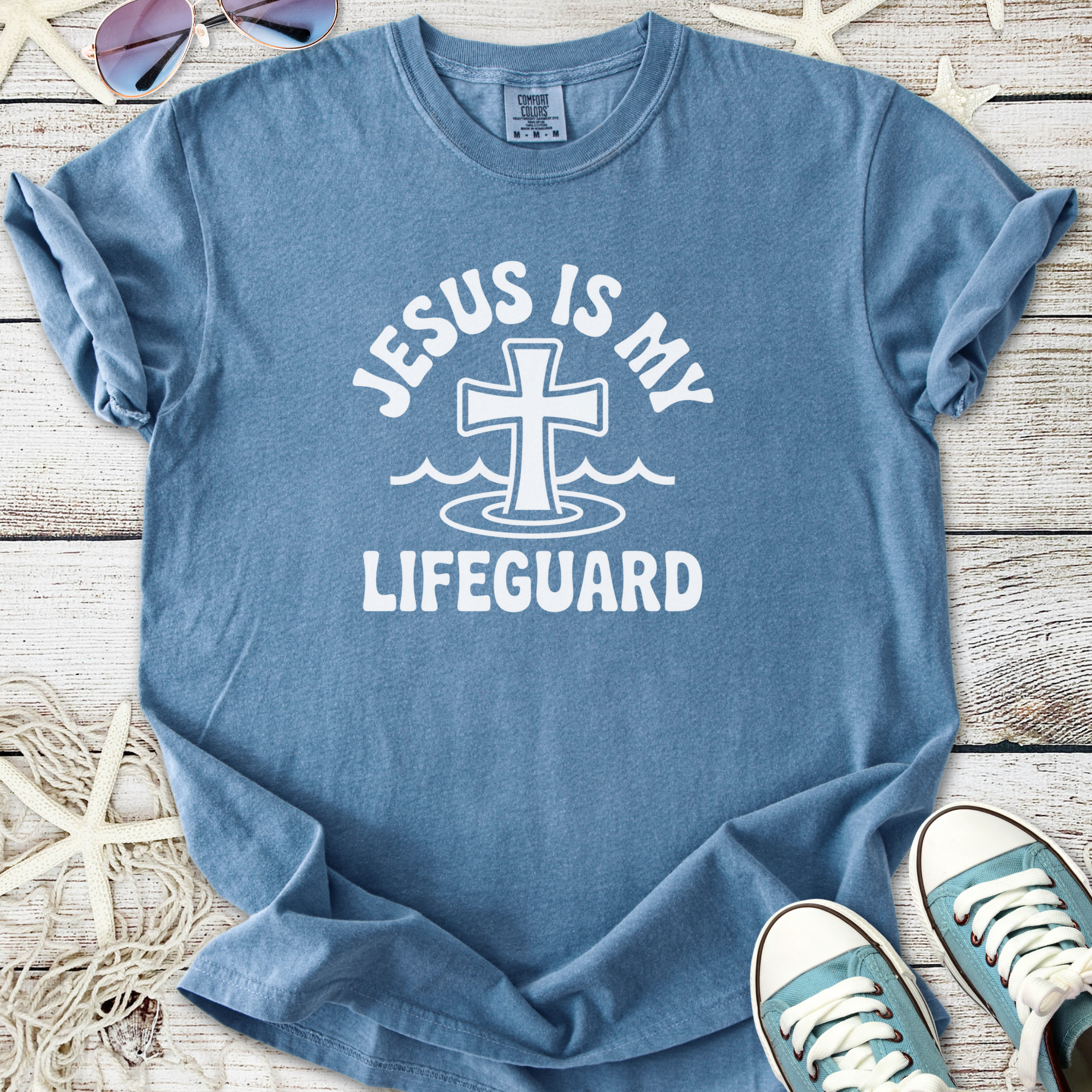 Light blue t-shirt with 'Jesus is My Lifeguard' graphic, made from soft cotton, perfect for casual wear.