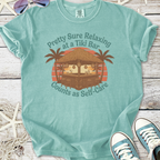 Mint green t-shirt featuring tiki bar graphic with palm trees and text about self-care.