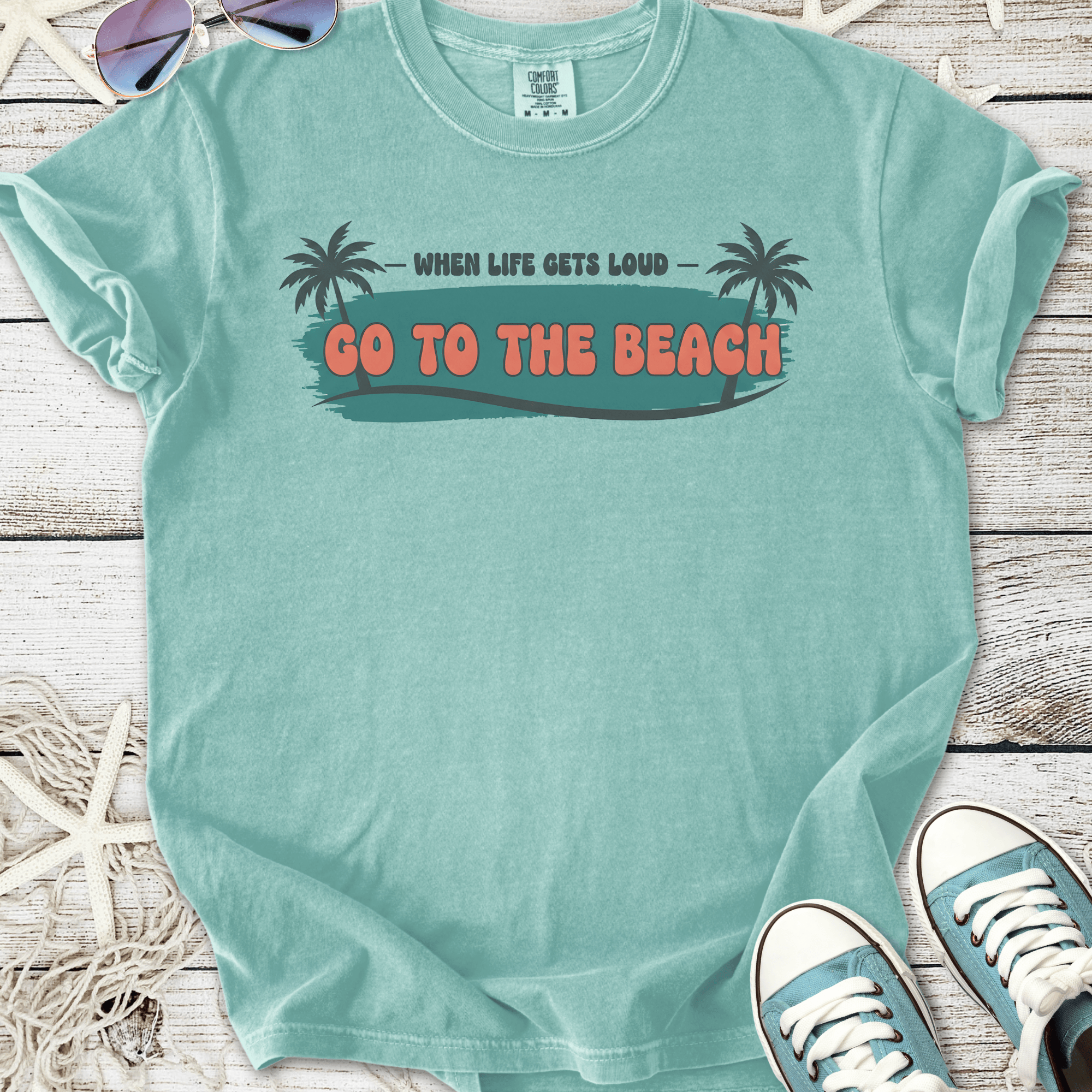 Light teal cotton t-shirt with 'Go to the Beach' graphic and palm tree design, perfect for summer vibes.
