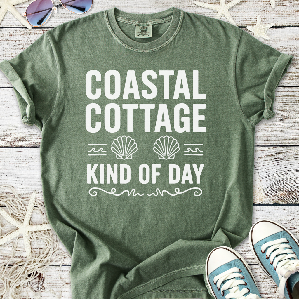 Green 'Coastal Cottage' tee, featuring seashell graphics, perfect for beach days and casual wear.