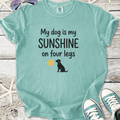 Light teal t-shirt featuring 'My dog is my SUNSHINE on four legs' with a dog and sun graphic.