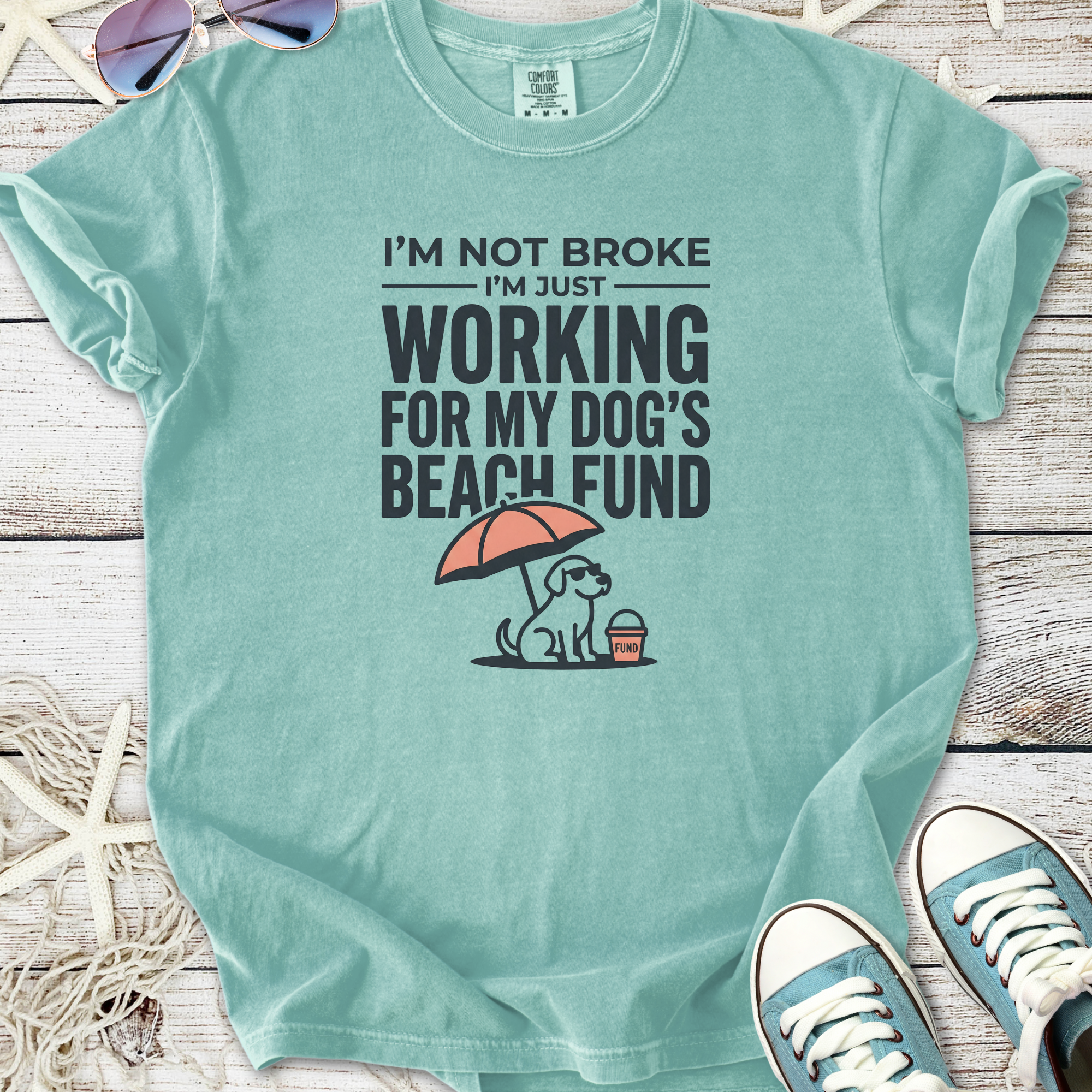 Mint green t-shirt with dog graphic and text 'Working for My Dog's Beach Fund', made of soft cotton.
