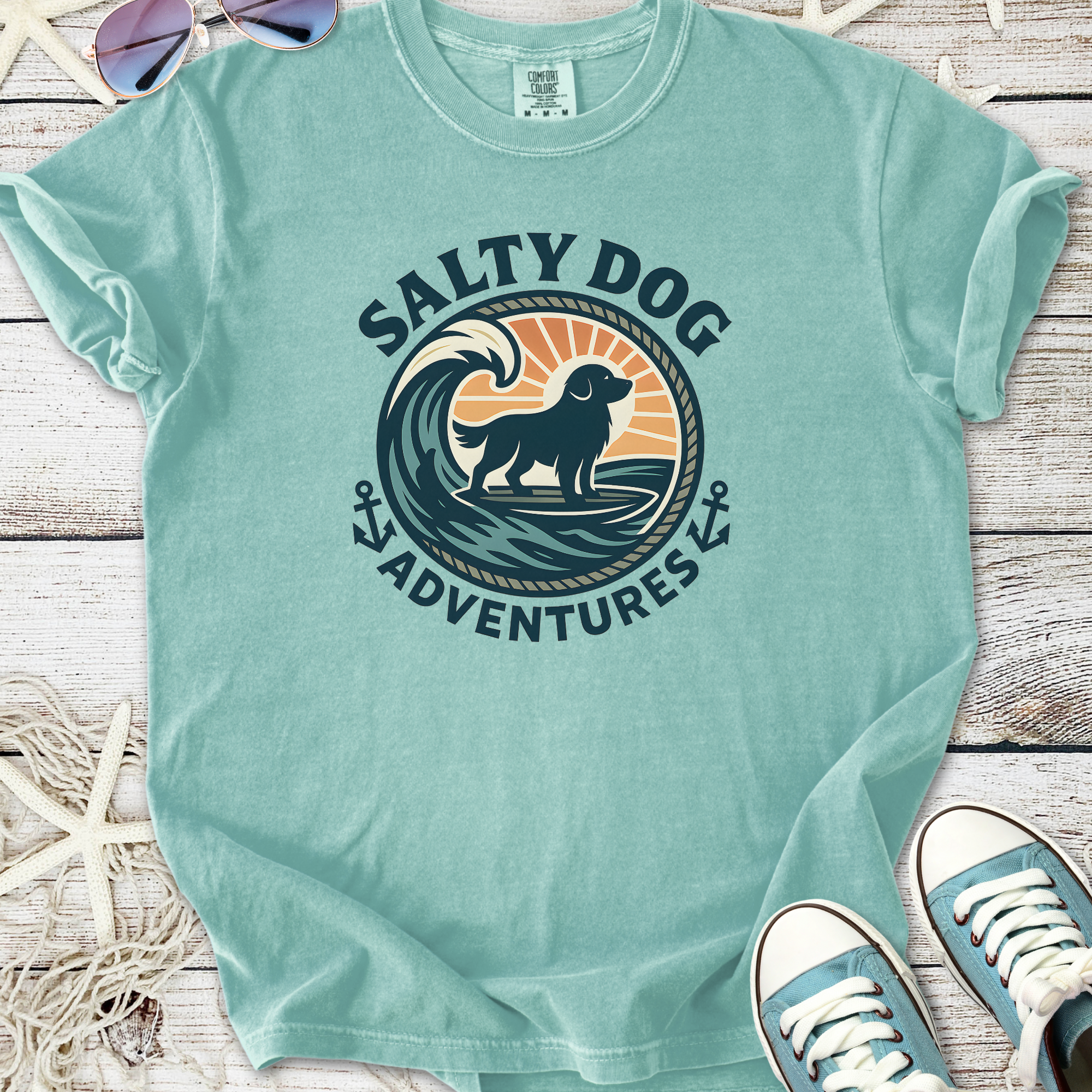 Light blue 'Salty Dog Adventures' t-shirt featuring a dog and wave graphic, perfect for beach lovers.