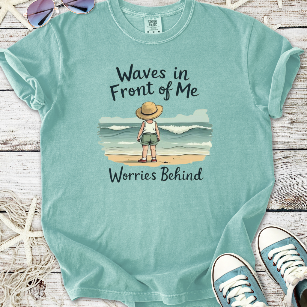 Mint green t-shirt featuring a child looking at waves with 'Waves in Front of Me, Worries Behind' text.