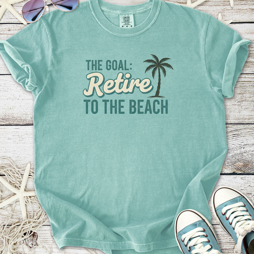 Light blue cotton t-shirt with 'Retire to the Beach' graphic, perfect for beach lovers and casual wear.