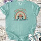 Mint green t-shirt with 'Retirement Plan' graphic, featuring a sunset and palm trees design.