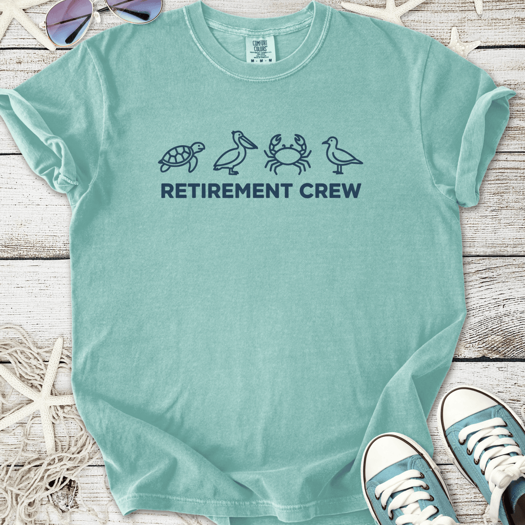 Light teal cotton t-shirt with 'Retirement Crew' and marine animal designs, perfect for casual retirement wear.