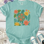 Aqua blue t-shirt featuring a colorful turtle and floral embroidery design, perfect for casual summer wear.