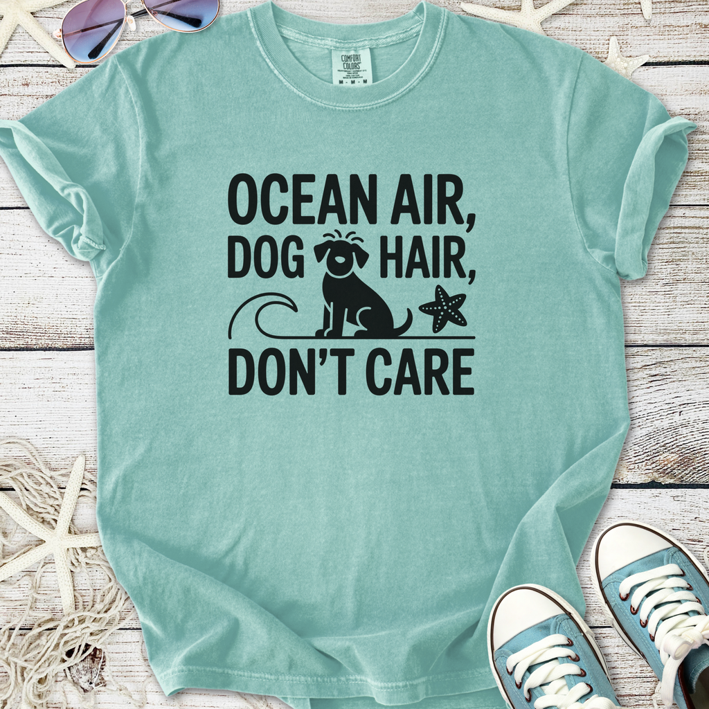 Mint green t-shirt featuring "Ocean Air, Dog Hair, Don't Care" graphic, perfect for dog lovers.