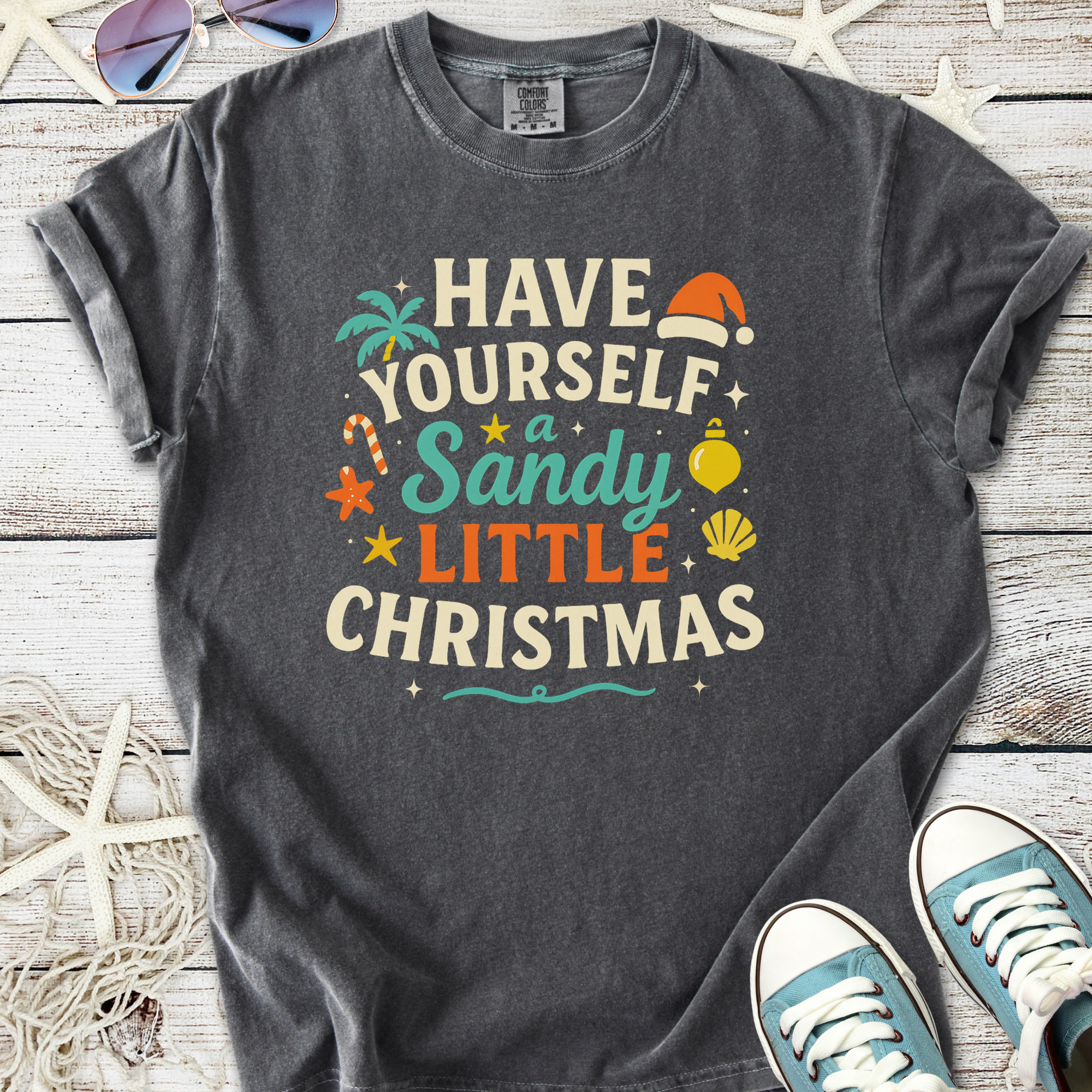 Dark gray graphic t-shirt with 'Have Yourself a Sandy Little Christmas' print, perfect for festive beach lovers.