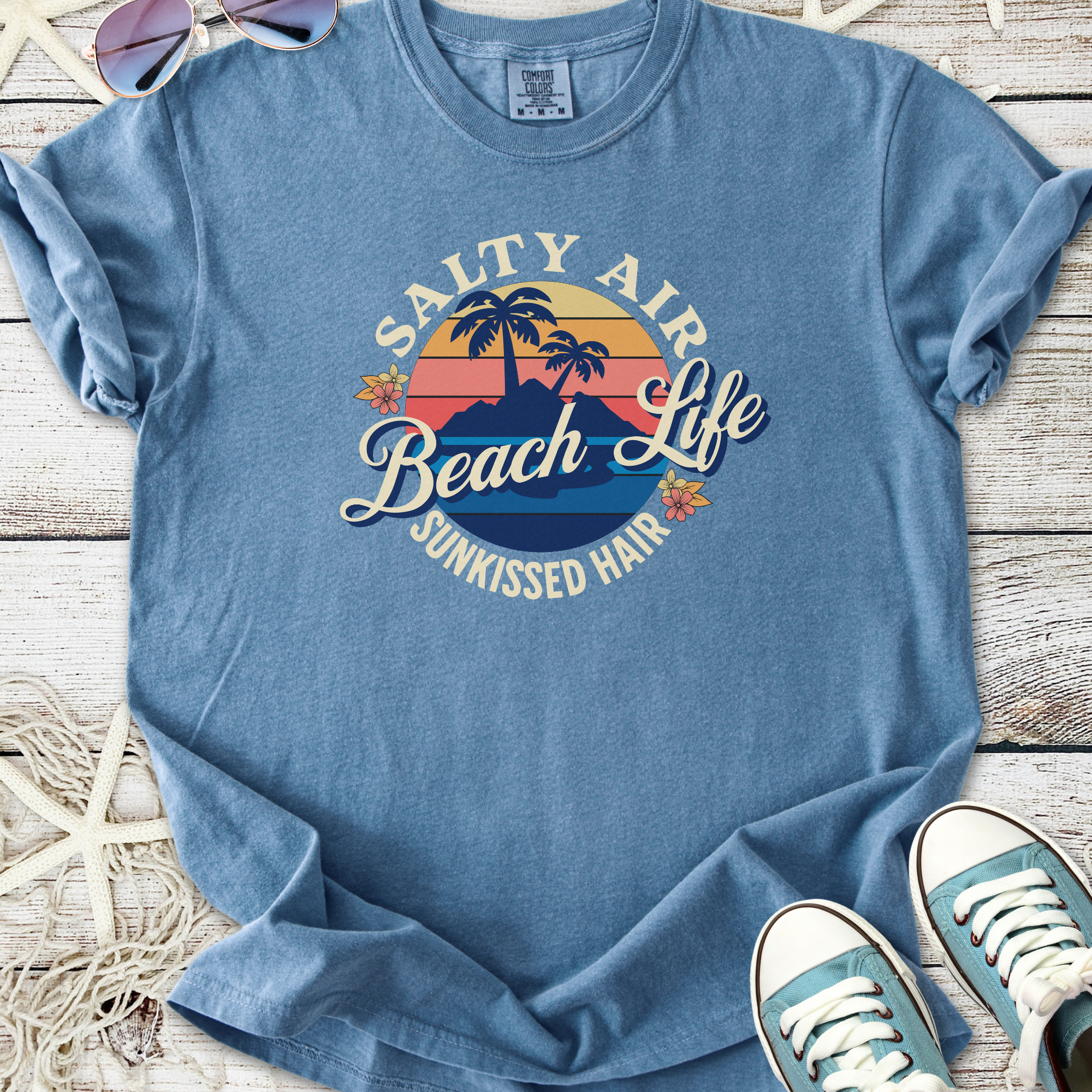 Light blue graphic tee featuring 'Salty Air Beach Life' design, perfect for summer outings.