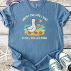 Blue graphic tee featuring a duck with the text 'Sorry I'm Late I Was Shell Collecting', perfect for casual wear.
