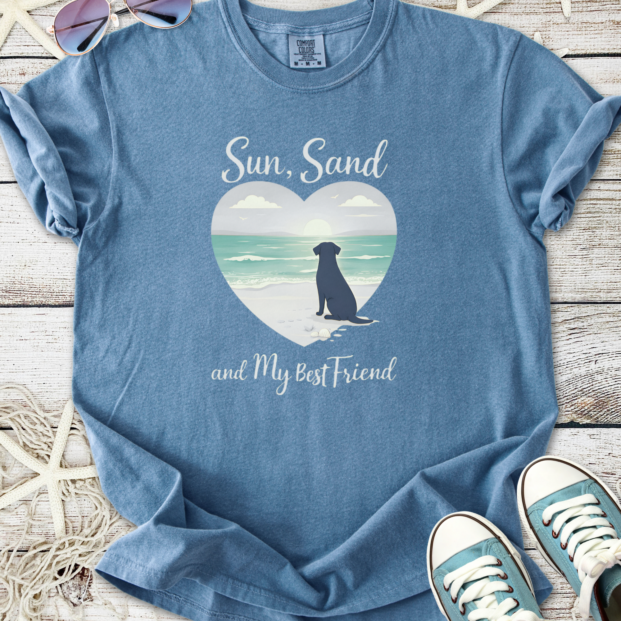 Blue graphic t-shirt with 'Sun, Sand and My Best Friend' featuring a beach scene and a dog silhouette.