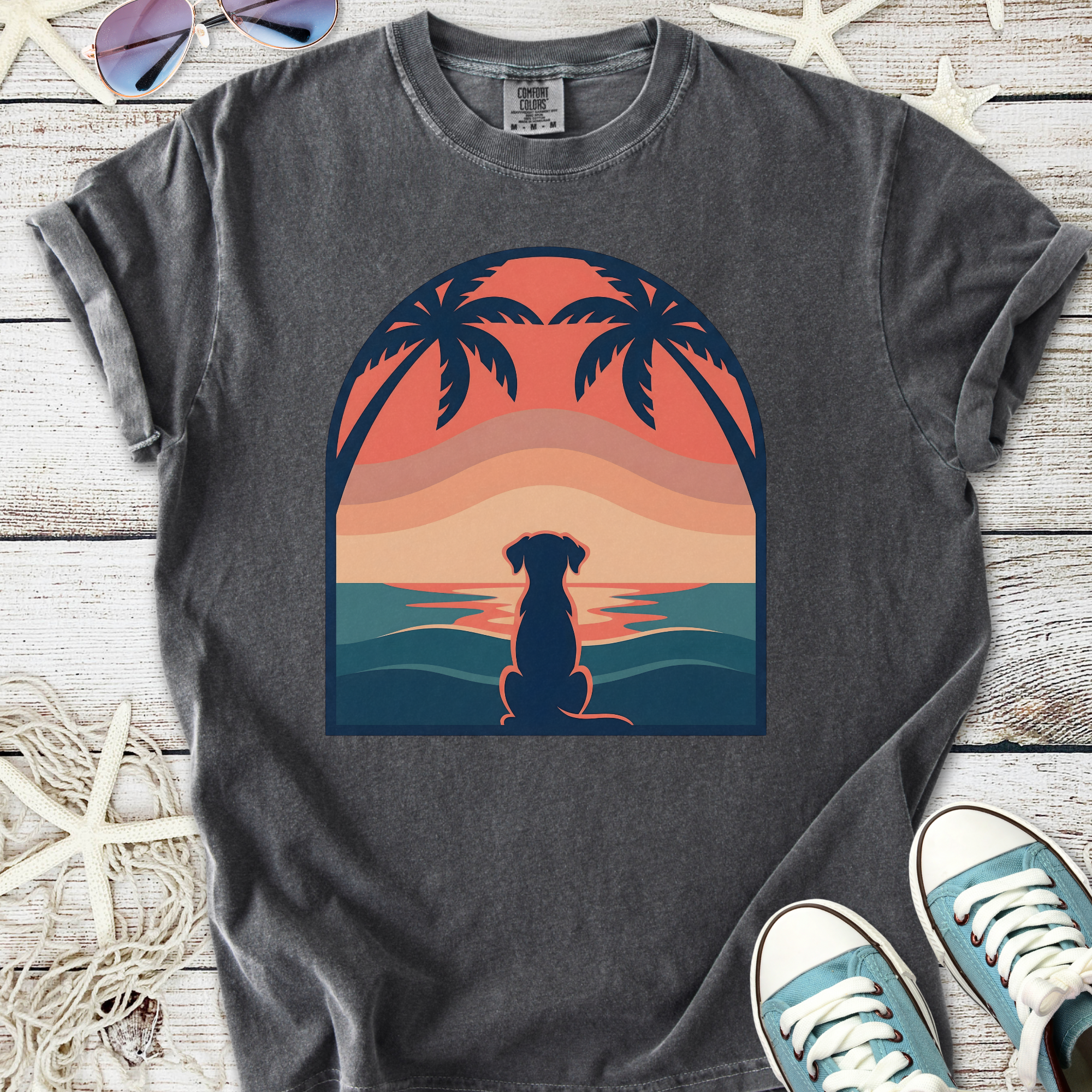 Graphite gray T-shirt featuring a dog silhouette against a sunset with palm trees.