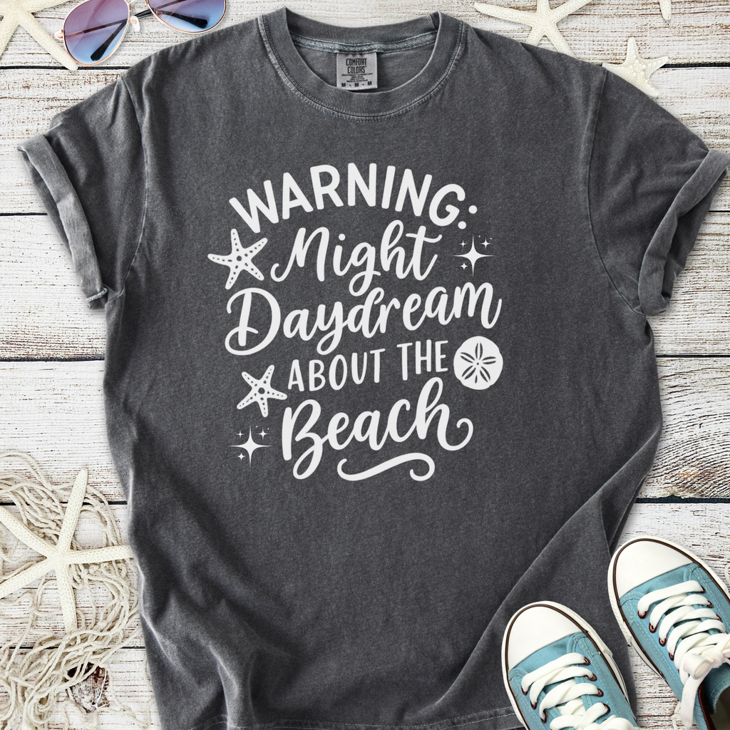 Gray unisex t-shirt with beach-themed graphic and text warning about daydreaming, perfect for summer.