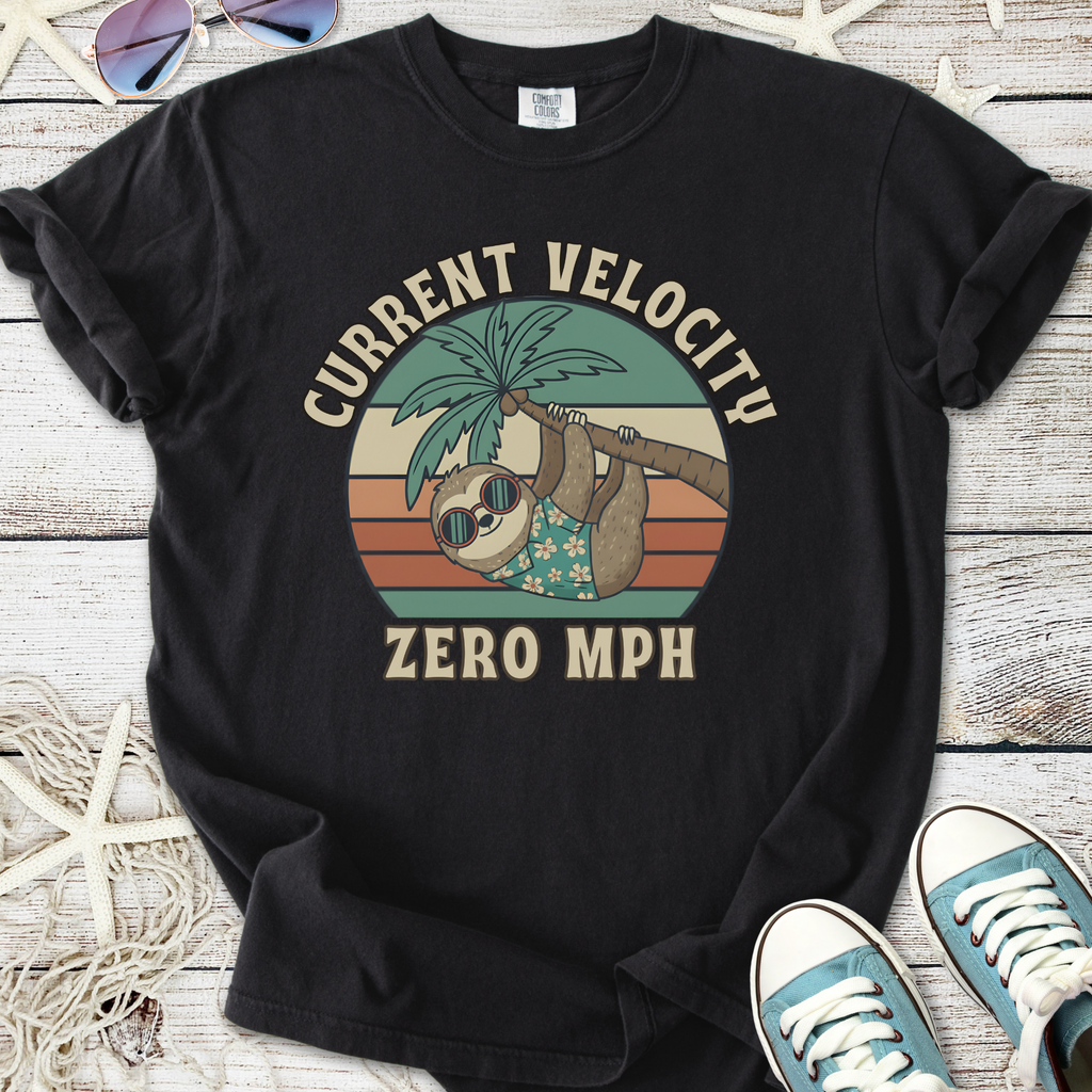 Black cotton T-shirt featuring a sloth graphic with sunglasses and palm tree, slogan 'Current Velocity Zero MPH'.