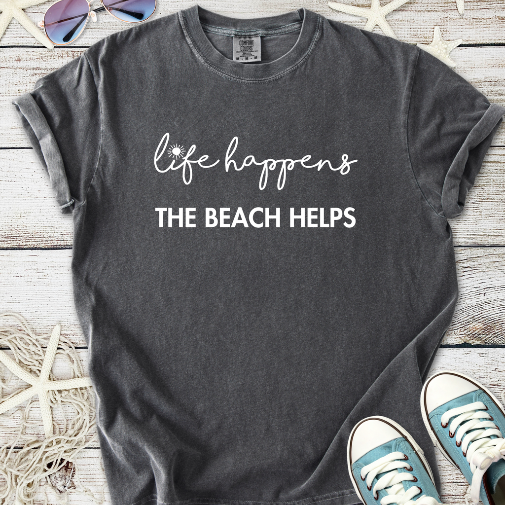 Gray unisex t-shirt with "life happens the beach helps" slogan in white lettering, perfect for casual beachwear.