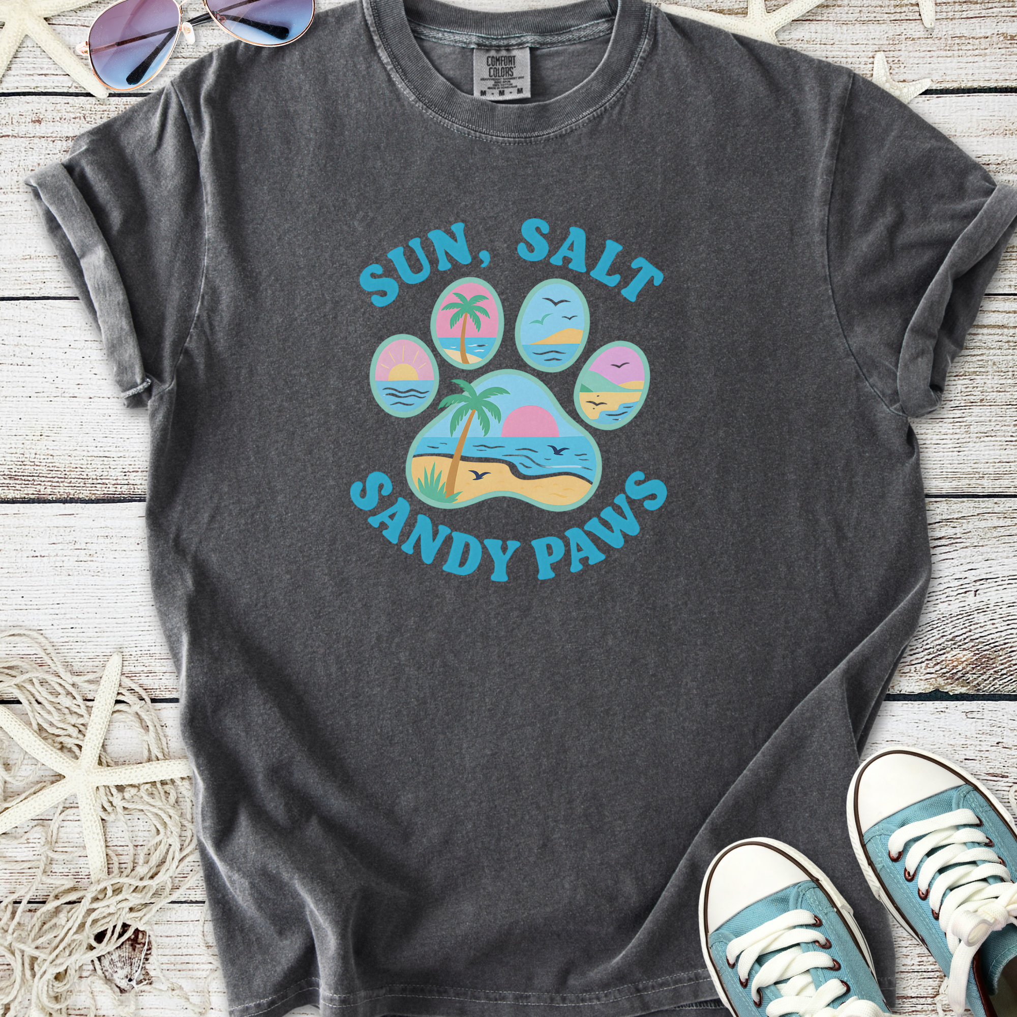 Charcoal gray t-shirt with 'Sun, Salt, Sandy Paws' graphic featuring beach and palm tree design.