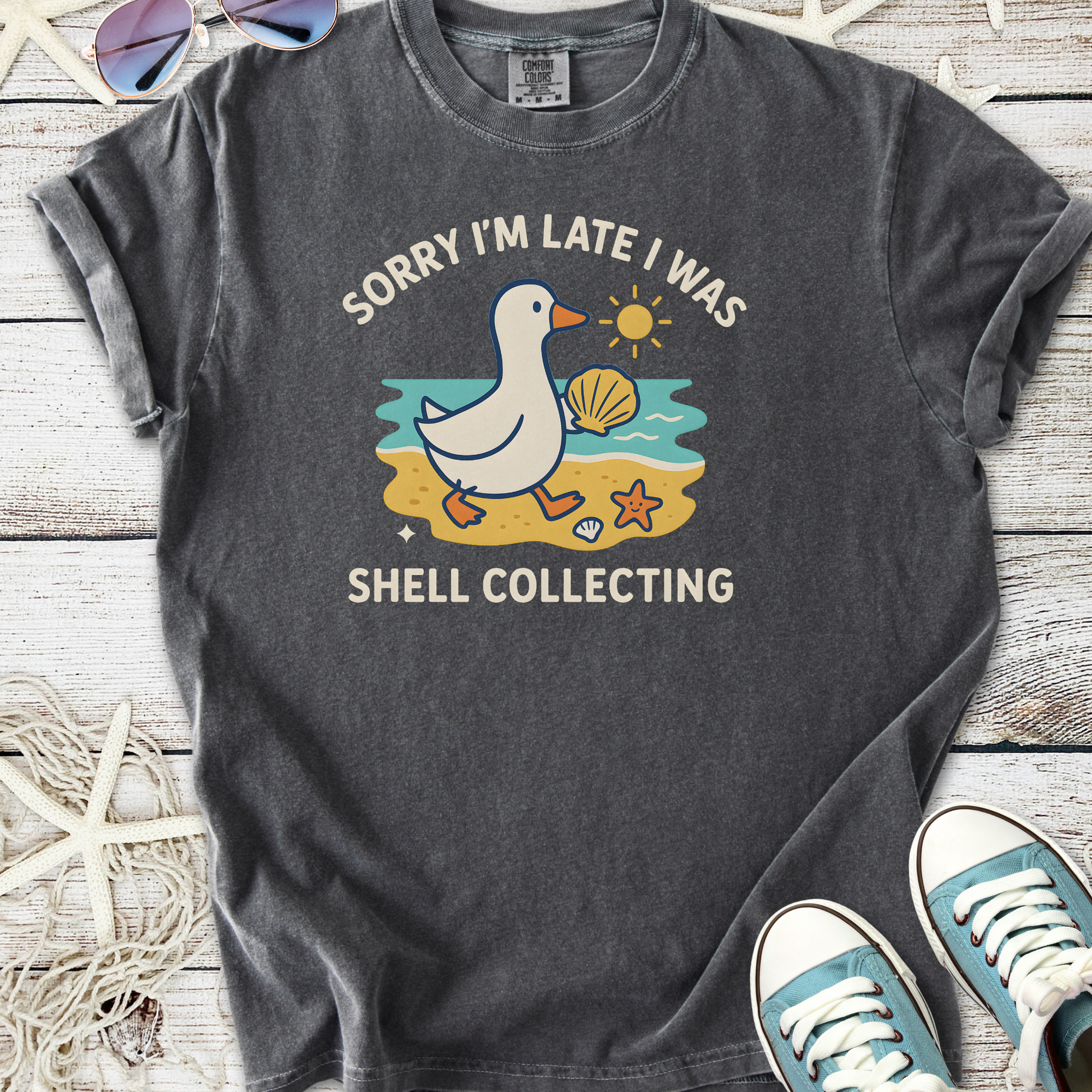 Funny gray T-shirt with a duck graphic saying 'Sorry I'm late I was shell collecting'