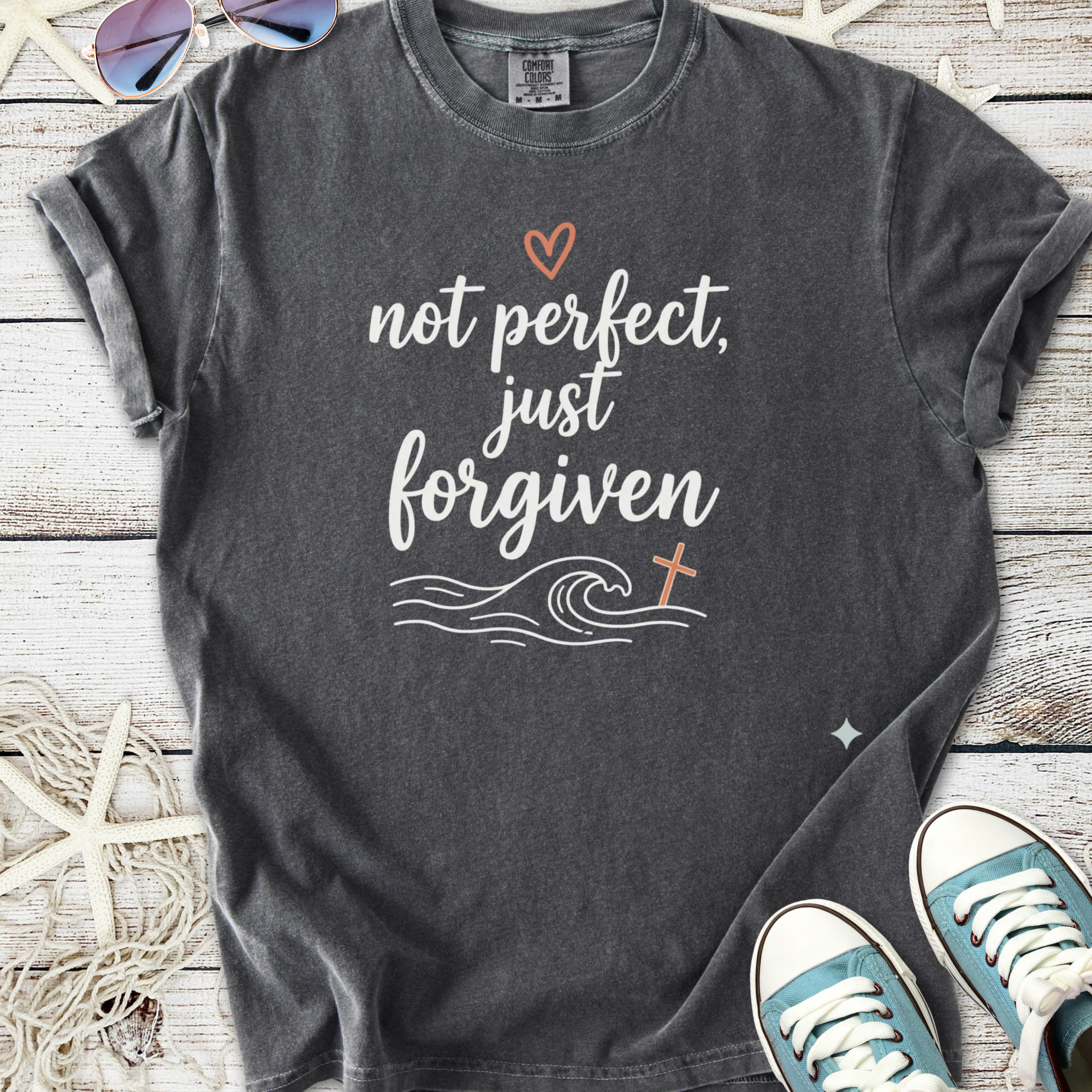 Dark gray faith based graphic t-shirt with ocean wave, cross, and ‘Not perfect, just forgiven’ text