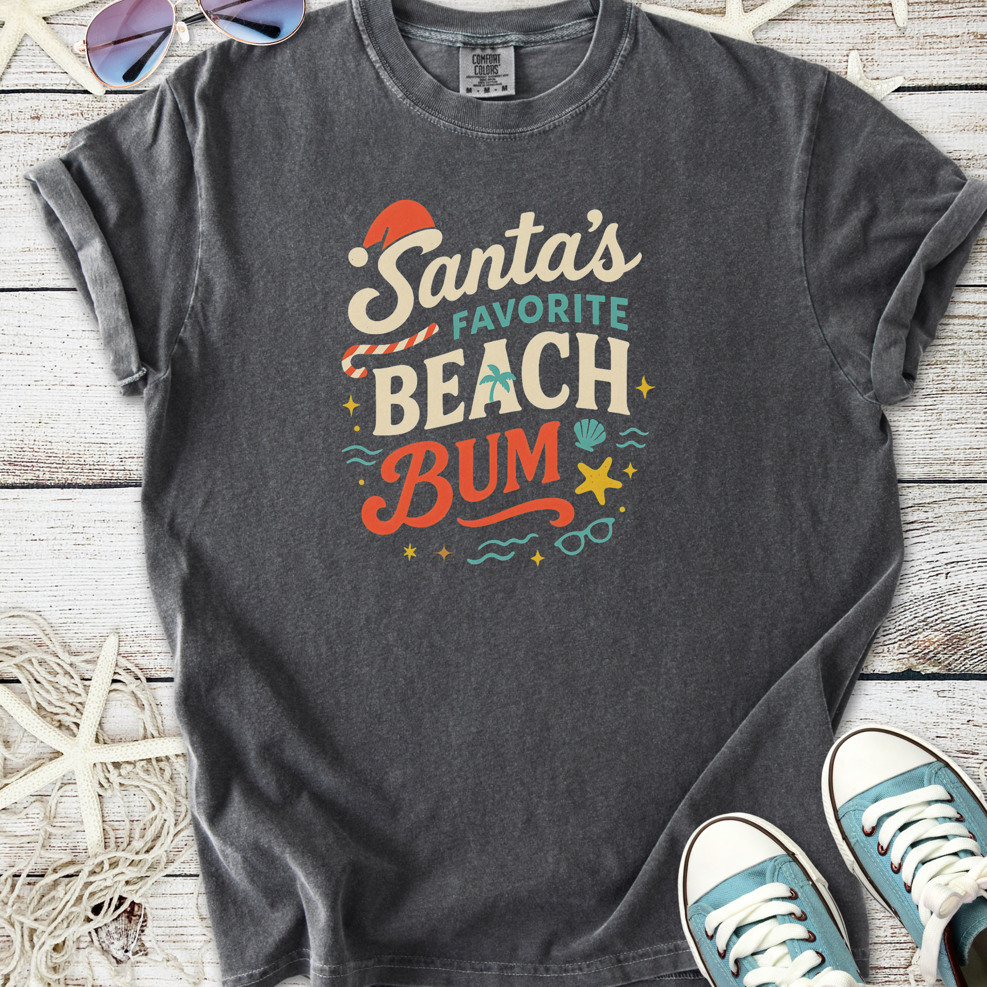 Gray t-shirt featuring 'Santa's Favorite Beach Bum' graphic in colorful print, perfect for festive beachwear.