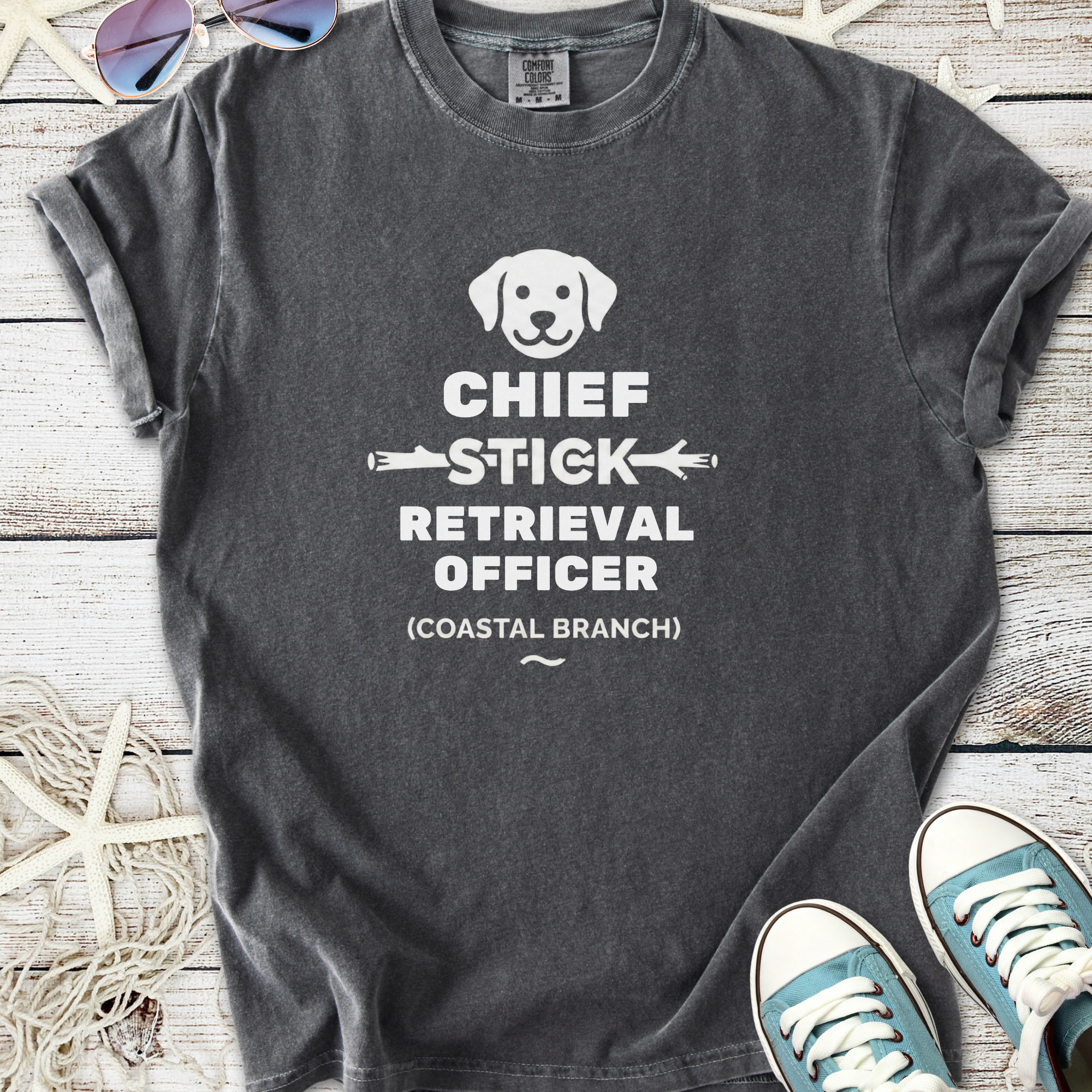 Gray graphic t-shirt featuring 'Chief Stick Retrieval Officer' with a dog icon, perfect for dog lovers.