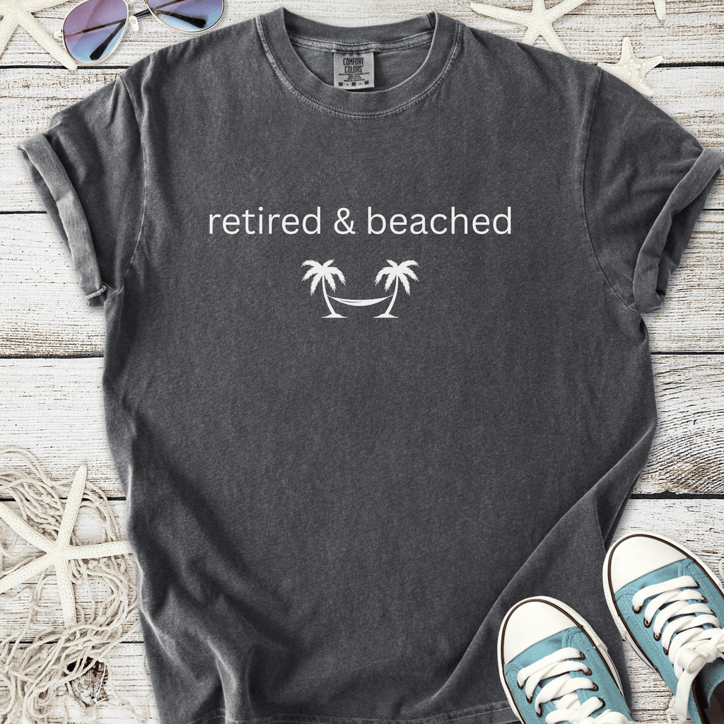 Gray cotton t-shirt with 'retired & beached' palm tree graphic, perfect for beach lovers.