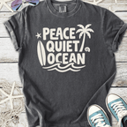 Gray graphic t-shirt featuring 'Peace Quiet Ocean' design with palm trees and surfboard, perfect for beach lovers.