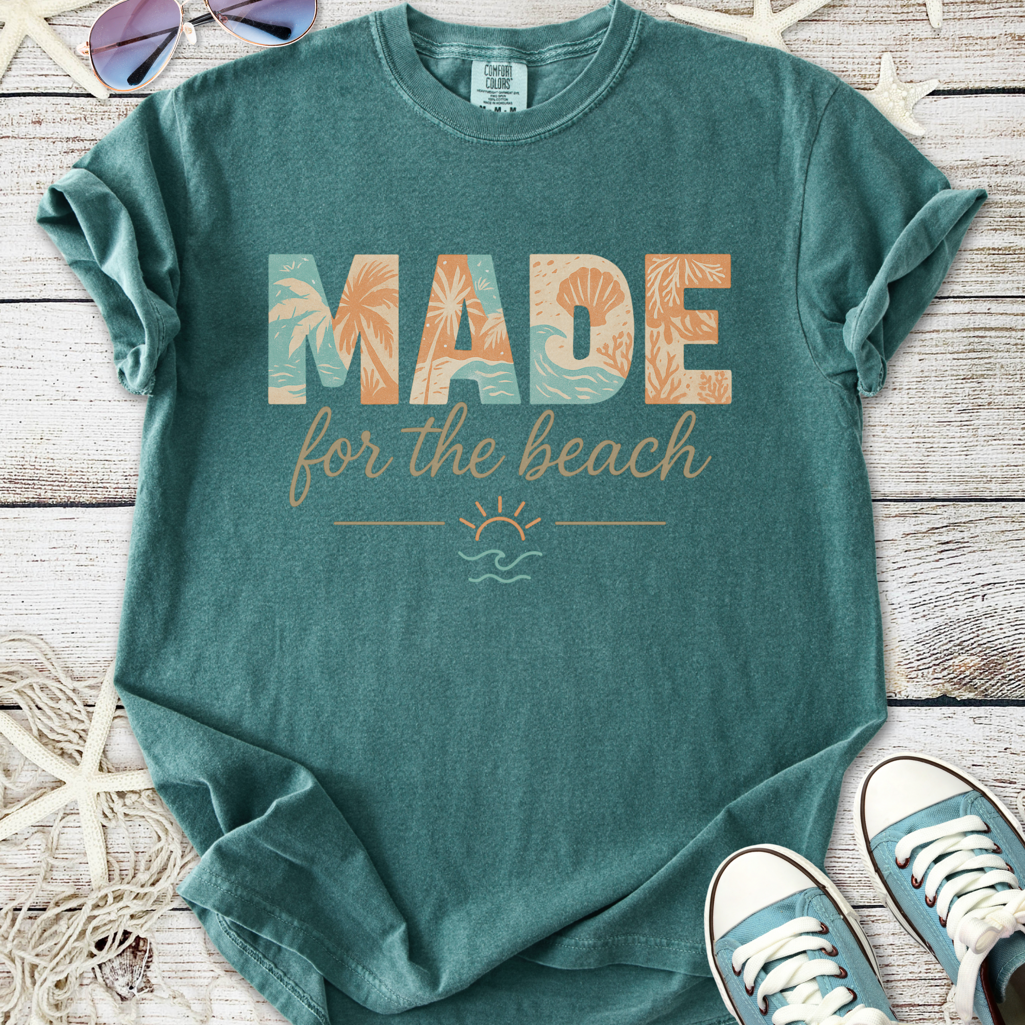 Teal graphic tee with 'MADE for the beach' design, comfortable cotton for summer outings.