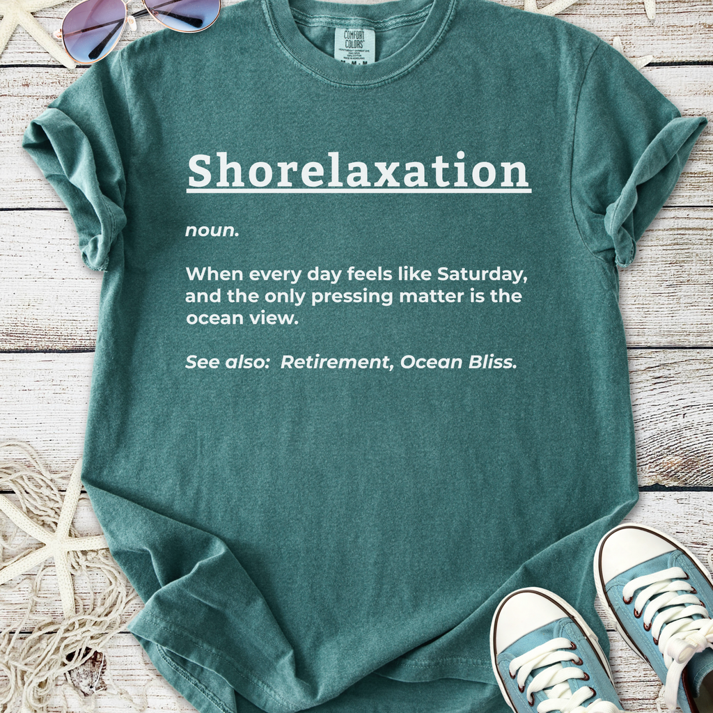 Teal cotton t-shirt with 'Shorelaxation' graphic text, perfect for beach lovers and relaxation enthusiasts.
