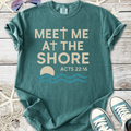 Teal graphic tee with 'Meet Me at the Shore' design and Acts 22:16 verse, made of soft cotton material.
