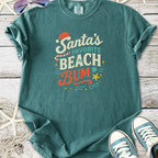 Teal cotton t-shirt with 'Santa's Favorite Beach Bum' graphic, ideal for festive beach lovers.