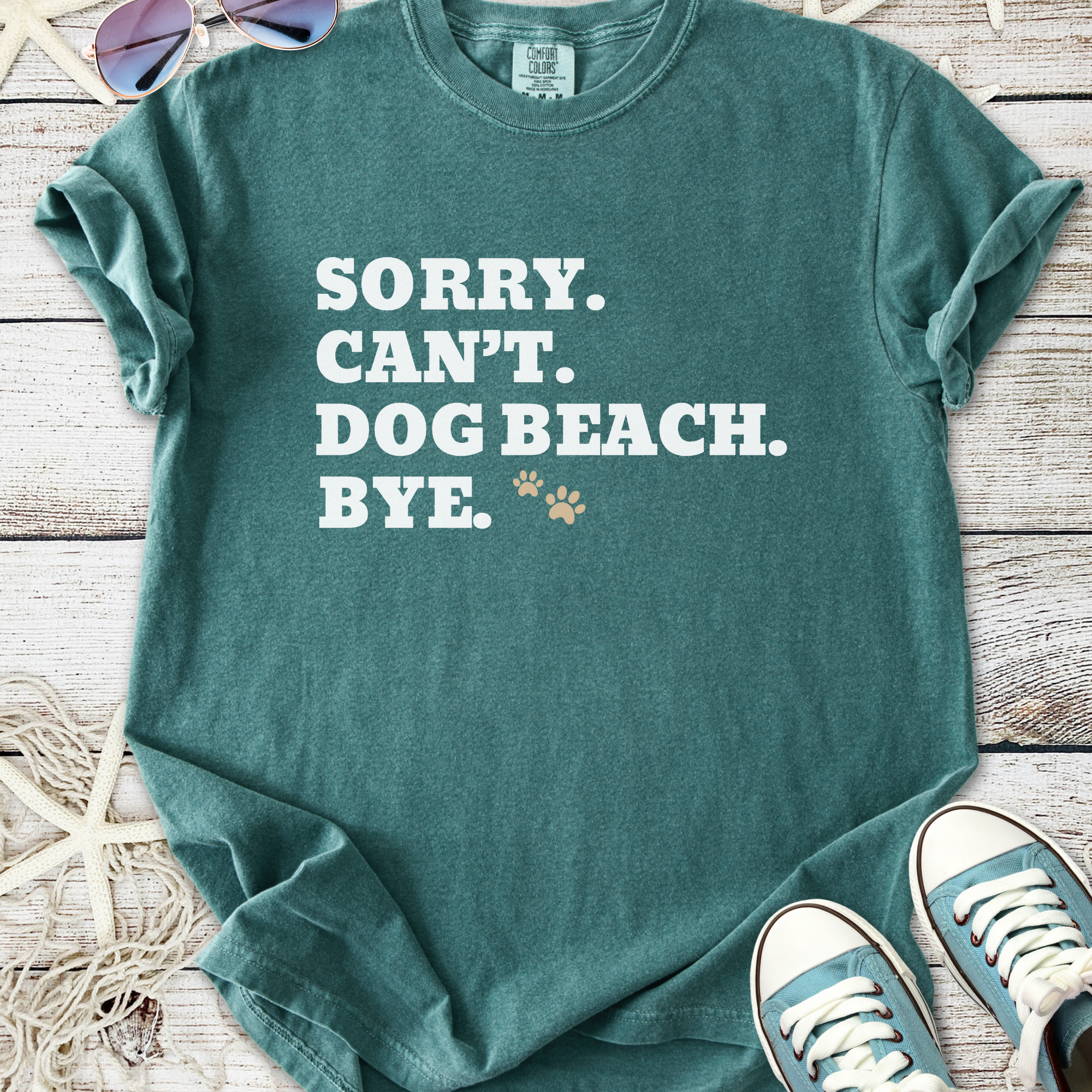 Teal graphic tee featuring the text 'Sorry. Can't. Dog Beach. Bye.' in bold white letters.