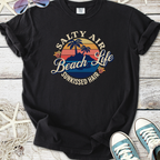 Black graphic t-shirt with 'Salty Air Beach Life Sunkissed Hair' design and palm tree motif.
