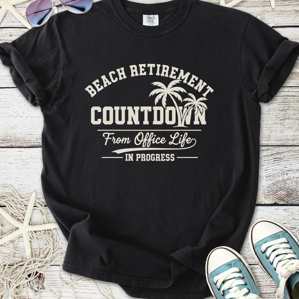 Black t-shirt featuring 'Beach Retirement Countdown' graphic, perfect for relaxed office escape.