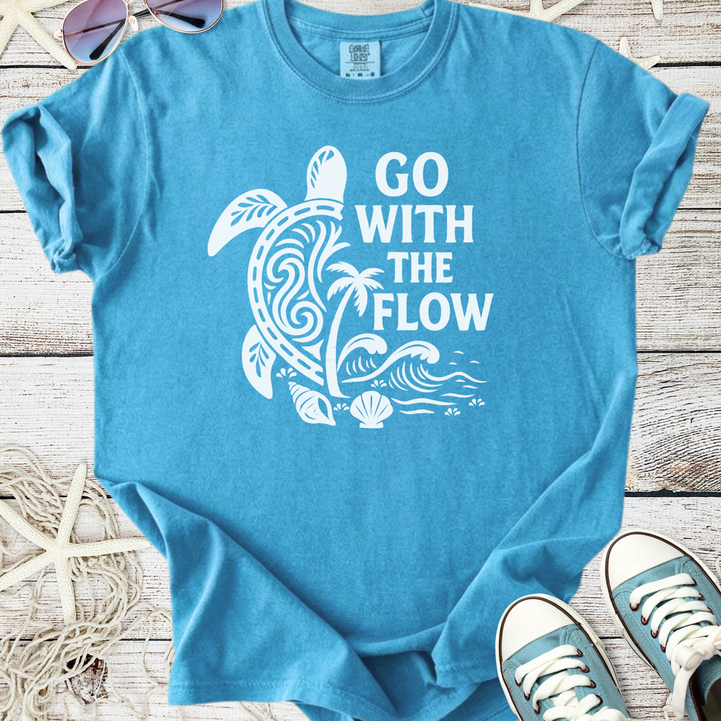 Light blue t-shirt with 'Go With The Flow' design and turtle graphic, made of soft cotton material.