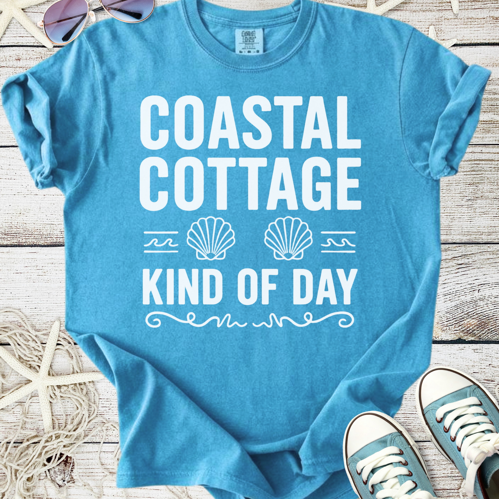 Light blue cotton t-shirt with 'Coastal Cottage Kind of Day' design, perfect for beach lovers.