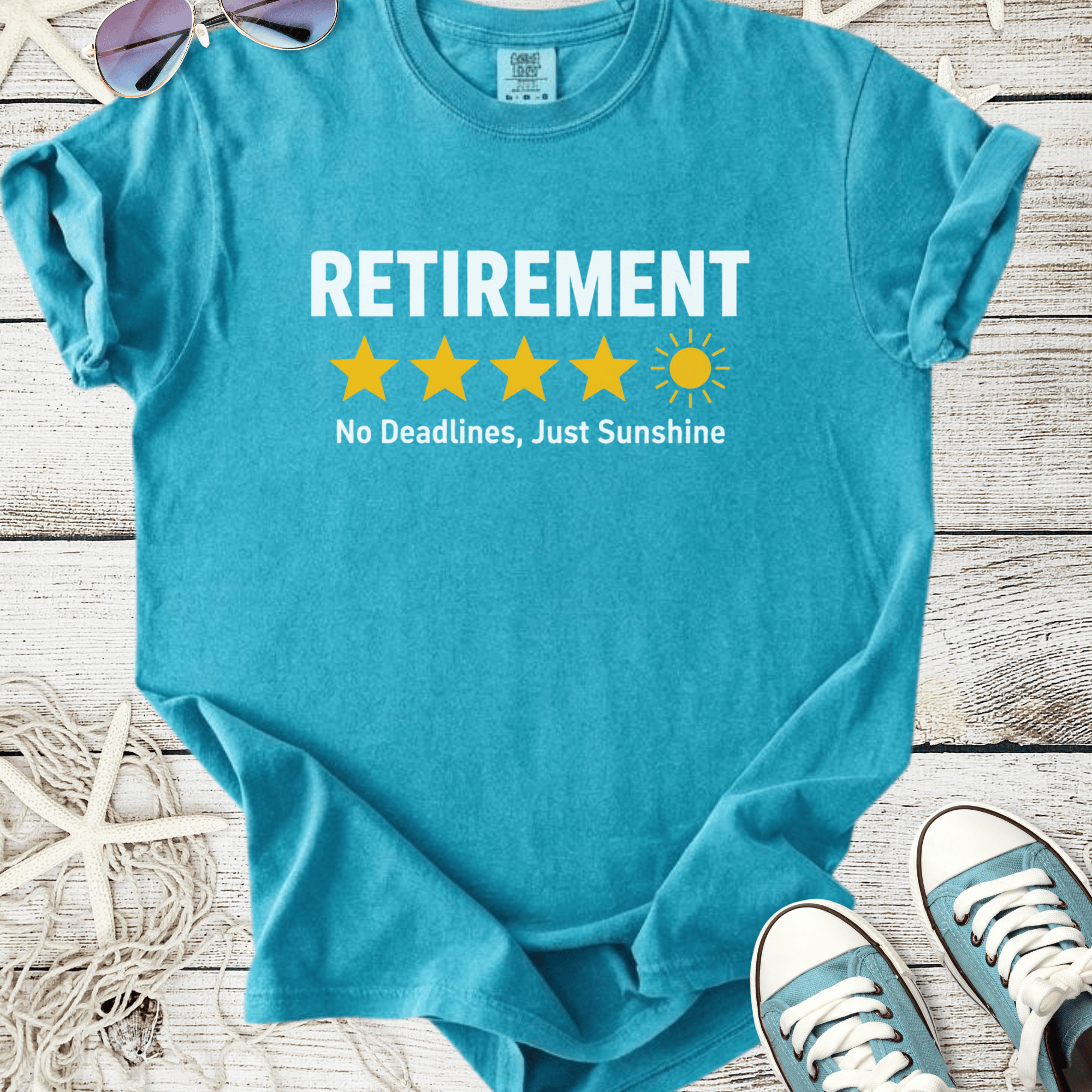 Turquoise retirement t-shirt with stars and sun graphic, featuring 'No Deadlines, Just Sunshine' slogan.