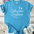 Light blue t-shirt with 'Saltwater & Scripture' graphic, casual style for beach lovers.