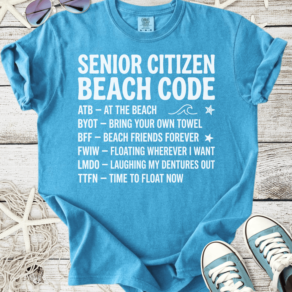 Light blue t-shirt with humorous senior citizen beach code graphics, perfect for summer outings.