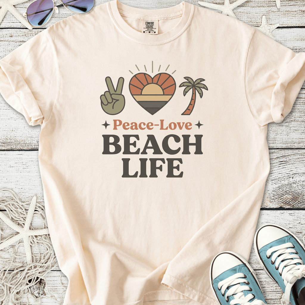 Cream cotton t-shirt with 'Peace-Love Beach Life' graphic, featuring palm tree and sunset design.