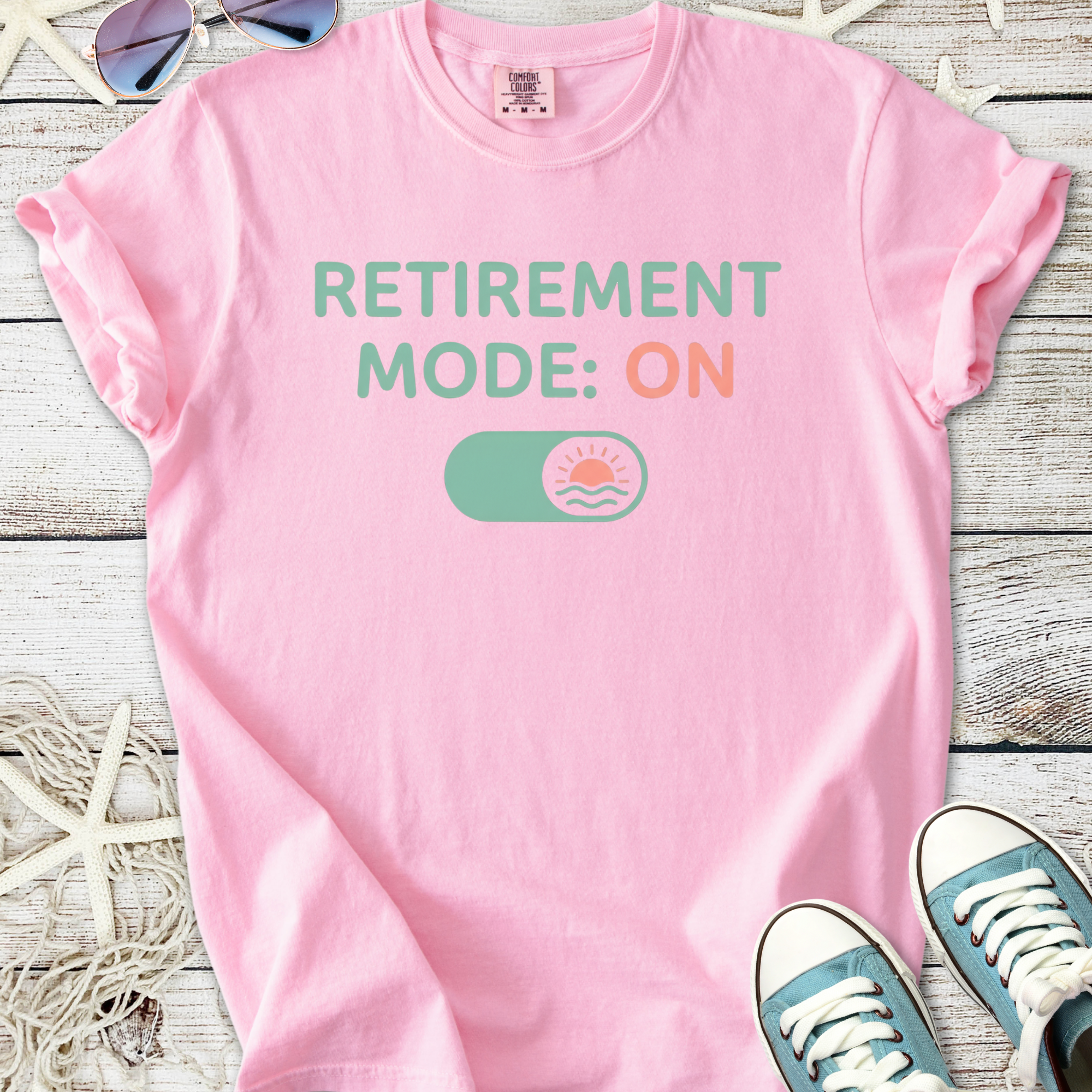 Pink cotton t-shirt with 'Retirement Mode: ON' graphic, perfect for casual wear.