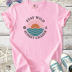 Pink 'Stay Wild Sunset Chaser' graphic t-shirt made of soft cotton, perfect for beach lovers.