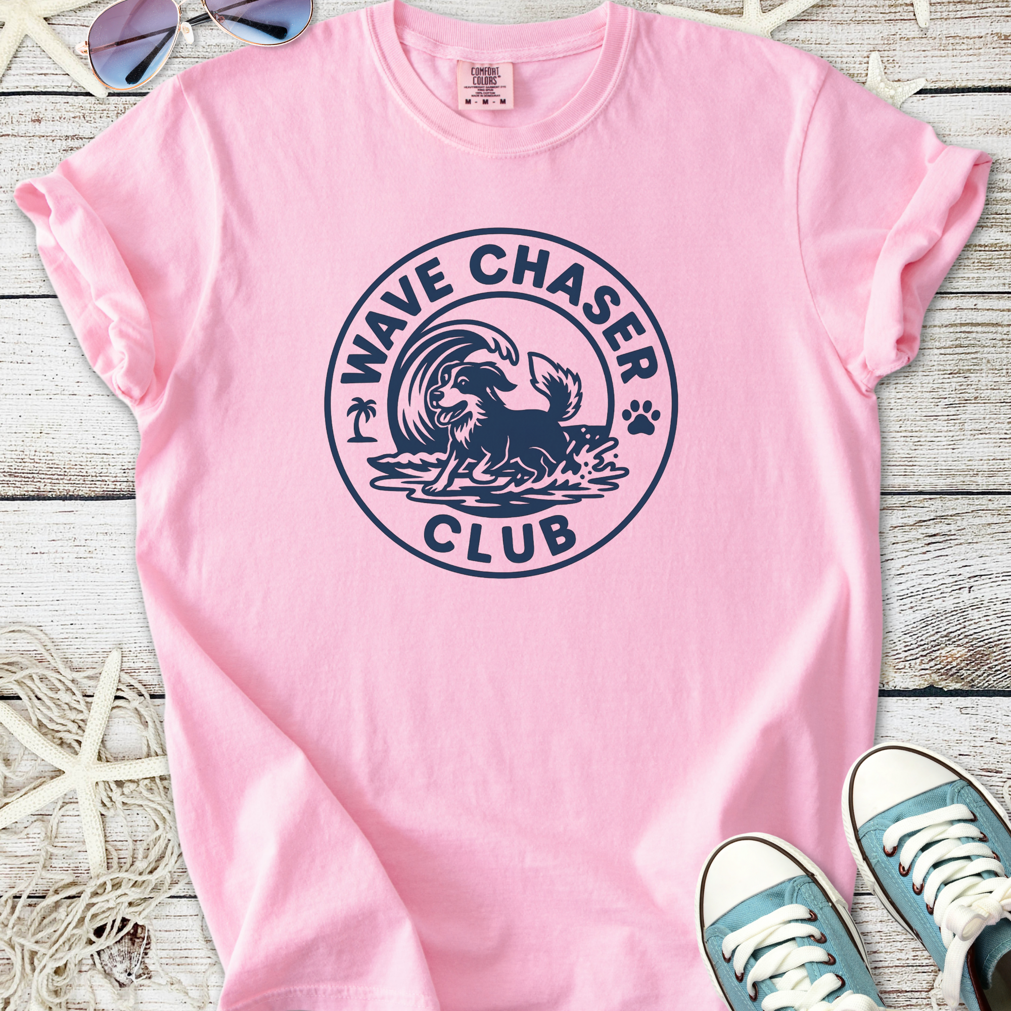 Pink cotton t-shirt with 'Wave Chaser Club' graphic featuring a dog surfing, perfect for beach lovers.
